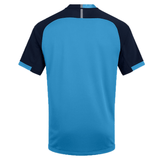 A blue and black short-sleeve Canterbury Vapodri Evader Jersey shown from the back, featuring a solid light blue body and darker blue sleeves with light blue trim. This jersey incorporates moisture-wicking technology to keep you dry and comfortable.