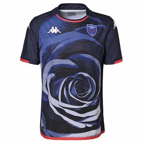 A Kappa home jersey featuring a large blue rose design, with the FC Grenoble Rugby crest on the left chest and a logo on the right chest, set against a dark blue background.