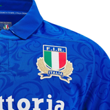 Close-up of a blue Italy 24/25 Replica Home Jersey by Macron, made from Eco Fightex Fabric, showcasing the F.I.R. Italia logo with a green, white, and red emblem encircled by laurel leaves.