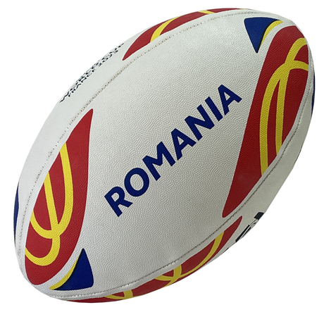 Introducing the Rugby World Cup 23 Romania Supporters Ball by Gilbert: a white rugby ball featuring the word "Romania" and decorated with vibrant red, yellow, and blue patterns. Ideal for Romania supporters during the Rugby World Cup 2023.