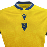 A yellow and blue ASM Clermont Auvergne Home Jersey 23/24 by Macron with the word sweden on it.