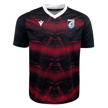 Black and red Macron Cardiff 22/23 Training Jersey featuring abstract red streaks across the chest, with a white club logo on the left and a white Macron brand logo at the right collarbone.