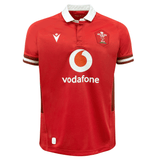 A red rugby shirt with the words Macron Wales Rugby Union 23/24 Home Jersey on it.