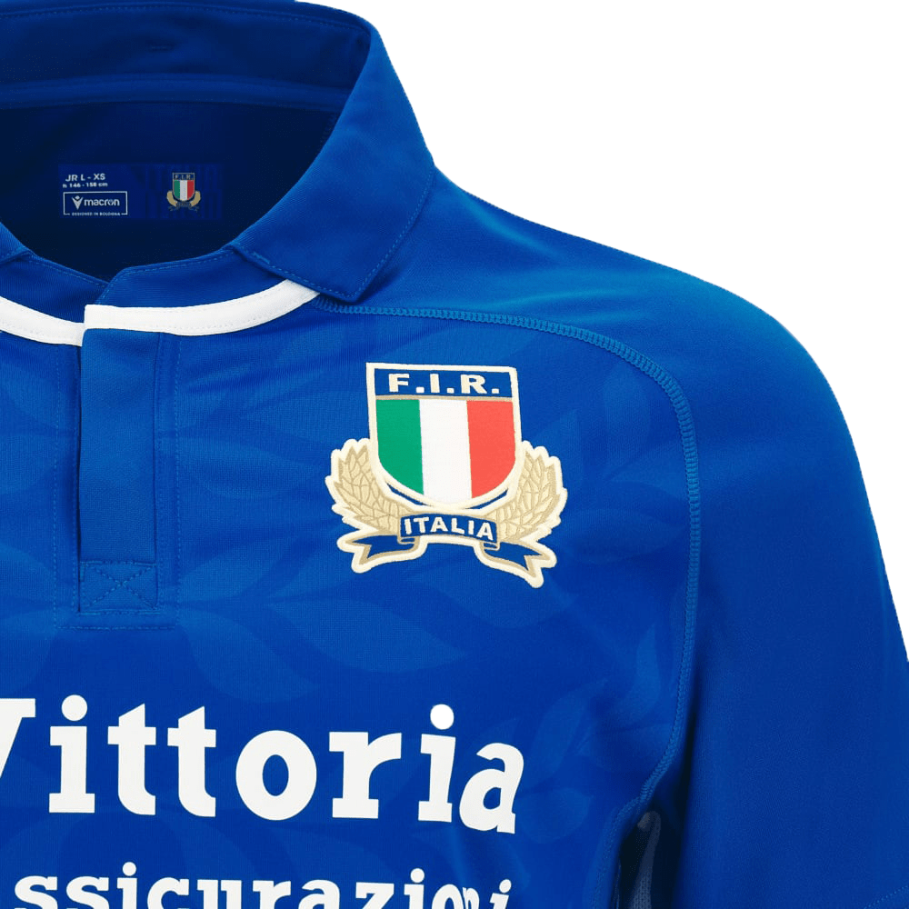 A blue rugby shirt with the logo of Italy FIR Home Jersey 23/24 by Macron on it.