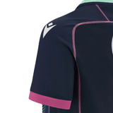 Close-up of the back of a dark blue Scotland Rugby Union Training Jersey 23/24 by Macron with pink accents and white arrows on the shoulder, showcasing stitching details and a portion of the sleeve.