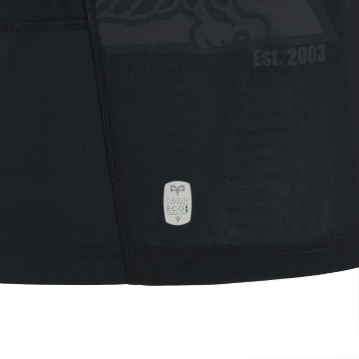 Close-up of a black, high-tech fabric featuring a small label with EcoVero certification and the text "Est. 2003" partially visible, reminiscent of the quality found in the Ospreys Home Jersey 23/24 by Macron.