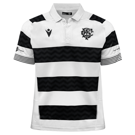 The Barbarians 23/24 Replica Jersey by Macron is a white polo shirt adorned with black horizontal stripes and a logo featuring intertwined letters on the left chest. Made from EcoFightex Material, the sleeves also feature black stripes and additional logos, encapsulating the spirit of the 2023/24 Replica Shirt.