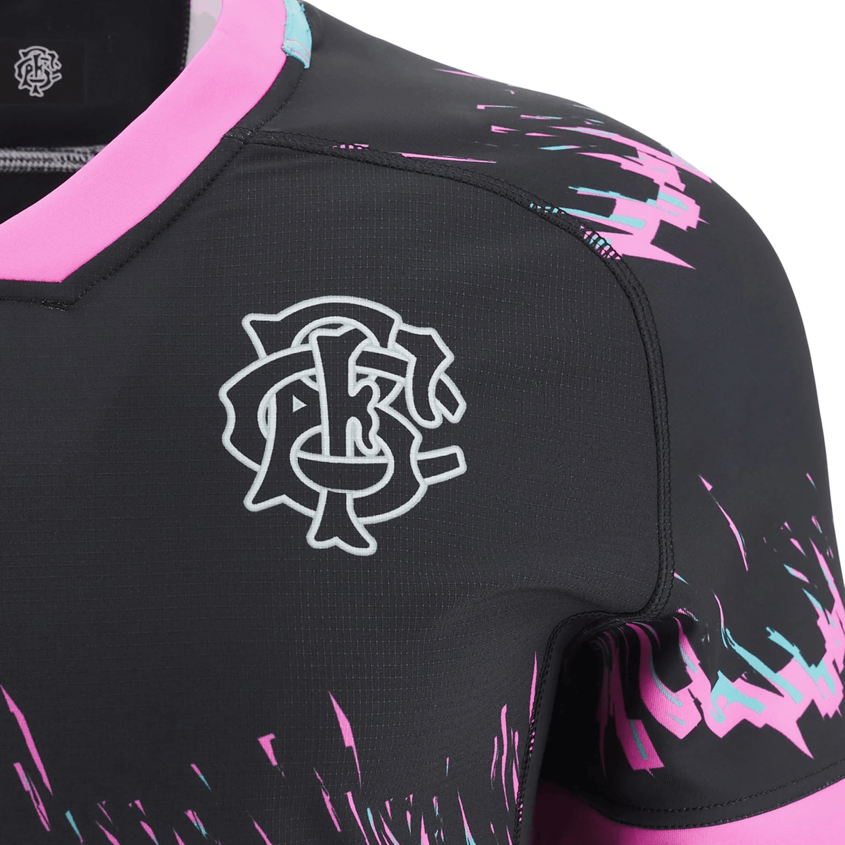 Close-up of a Barbarians 23/24 Training Jersey shoulder by Macron, featuring bright pink and blue splash patterns on a dark background.