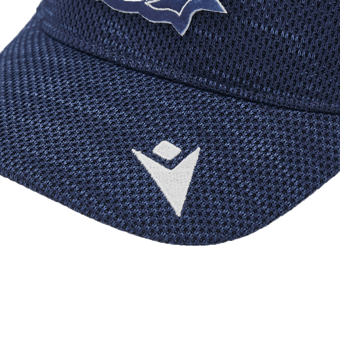 Close-up of the Scotland Trucker Cap 24/25 by Macron, featuring a blue mesh design with a white geometric logo and elements reminiscent of classic Scotland Rugby aesthetics in the background.