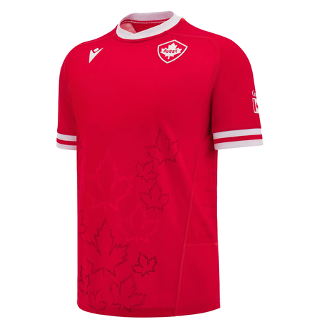 Introducing the Canada 24/25 Home Jersey by Macron: This red soccer jersey features white accents and maple leaf designs. It proudly displays a small shield logo on the upper chest, embodying national pride. Fans have been eagerly awaiting this latest edition from Macron.