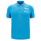 The Italy 24/25 Travel Polo by Macron is a blue polo shirt featuring a tricolor collar and sleeve trim, adorned with logos on the chest, including a shield and text. It perfectly combines style and sportiness, much like an Italy Rugby Polo designed by Macron.