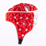 Introducing the Gilbert Air Headguard, a red and white padded headgear designed by Gilbert, featuring multiple ventilation holes, a chin strap, and excellent shock absorption for optimal protection.