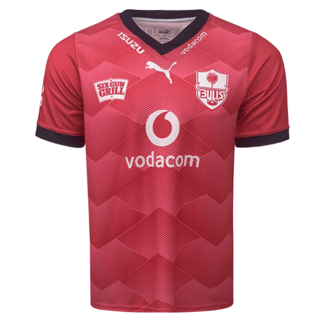 Front of light red with gradient accents jerseys. Vneck style collar with Izuzu & vodacom in white on the rim of the collar. white Puma logo center just below neck. Bulls logo on the left chest and Six Gun Frill on the right chest. Big Vodacom logo center front in white and red.