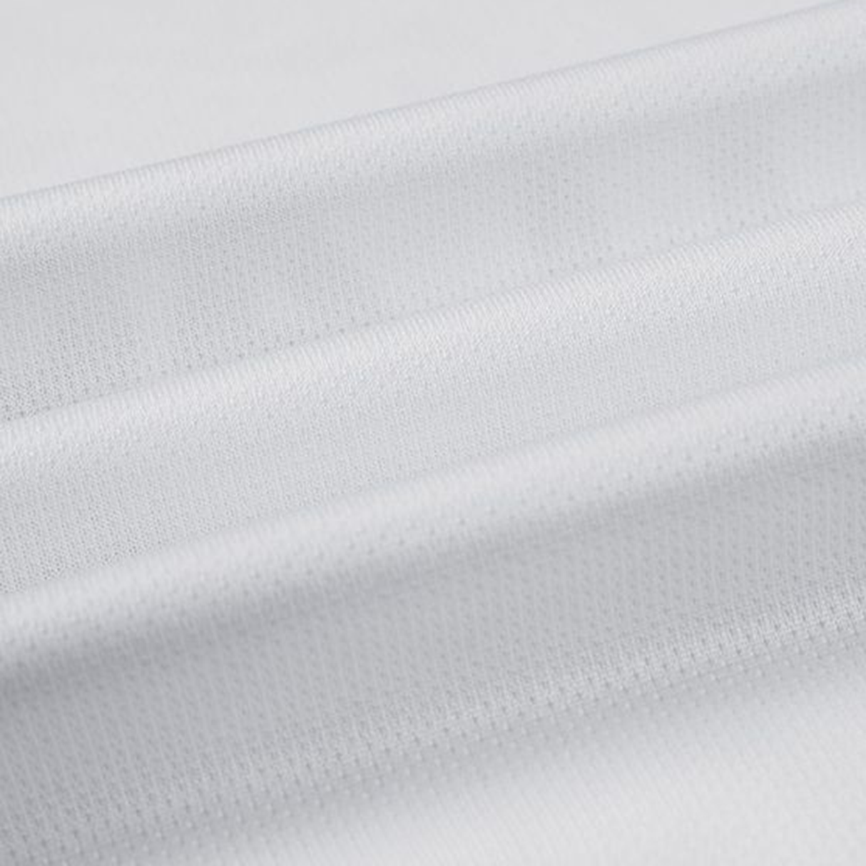 Close-up of a folded white fabric with a textured, grid-like pattern, reminiscent of the Gallagher Chiefs Super Rugby Away Jersey 24 by Classic Sportswear.