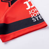 Close-up of a red and navy Crusaders Super Rugby Heritage Jersey by Classic Sportswear with the name "john stevenson" and the number 11 printed on it.