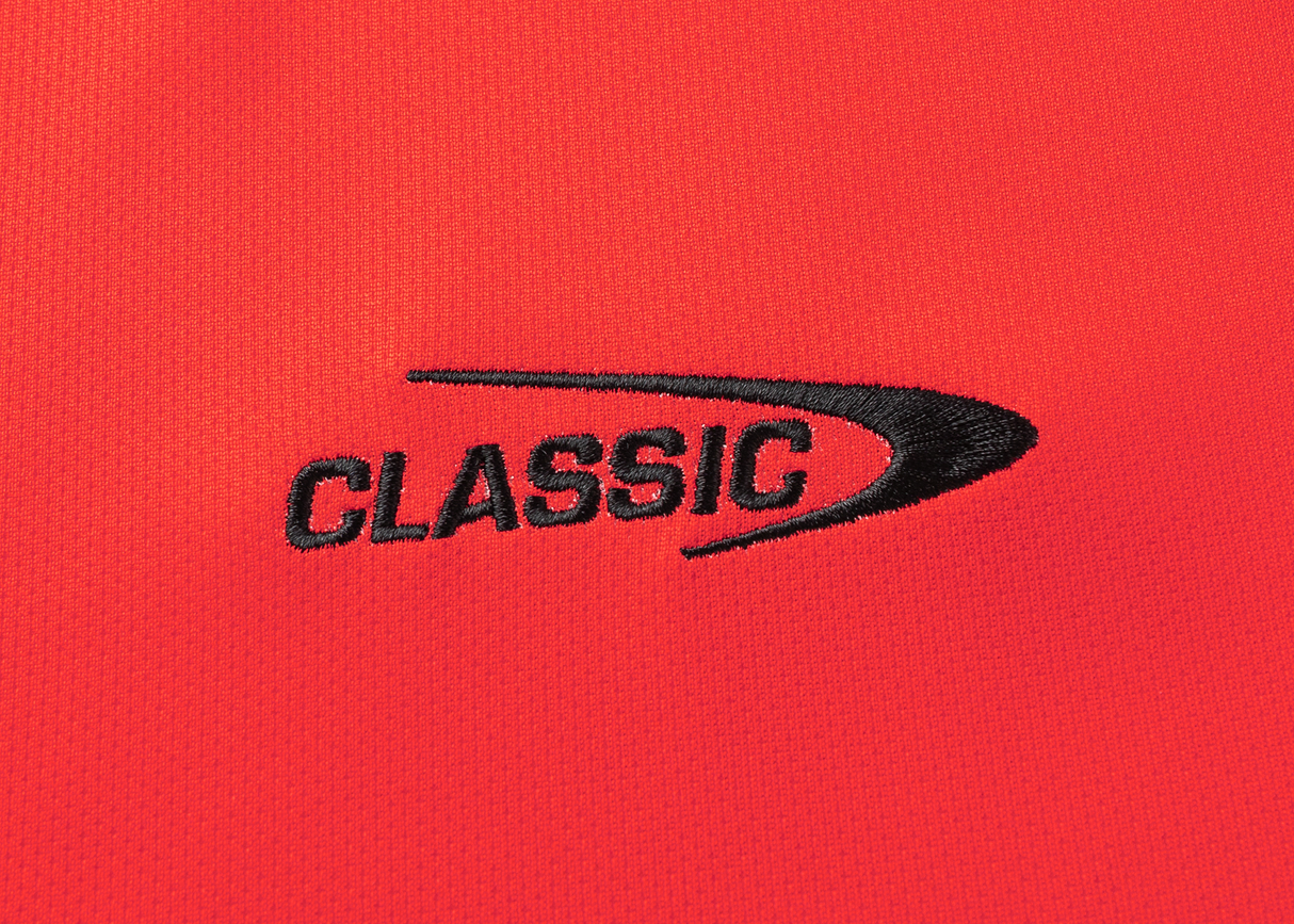 The Crusaders Super Rugby Replica Home Jersey 25/26 by Classic Sportswear showcases red fabric with "CLASSIC" stitched in black and a curved black design, capturing the Super Rugby legacy.