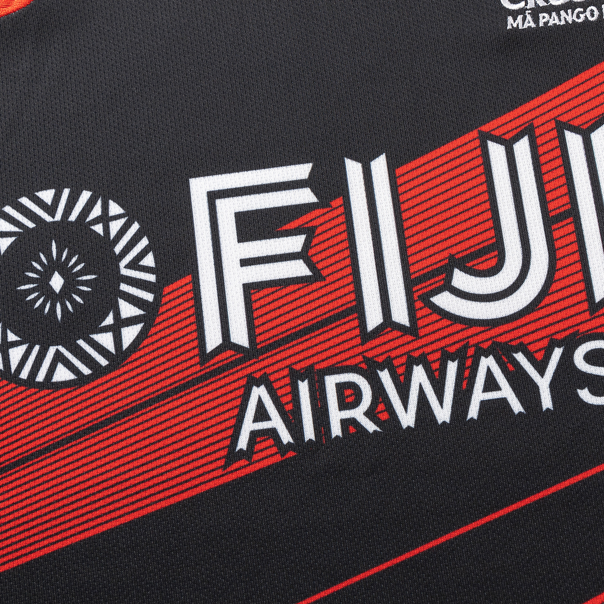 A close-up of the Crusaders Super Rugby Replica Away Jersey 25/26 by Classic Sportswear showcases "Fiji Airways" in bold lettering, seamlessly melding a geometric pattern with its classic black and red design.