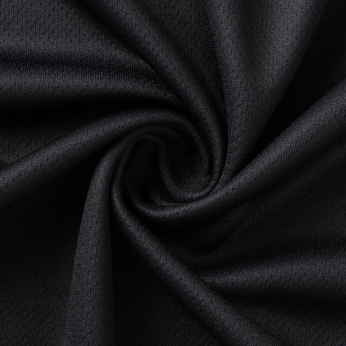 A close-up of black fabric with a swirling pattern highlights its texture and drape, reminiscent of the refined Crusaders Super Rugby Team Polo 25/26 by Classic Sportswear, showcasing premium moisture-wicking qualities.
.