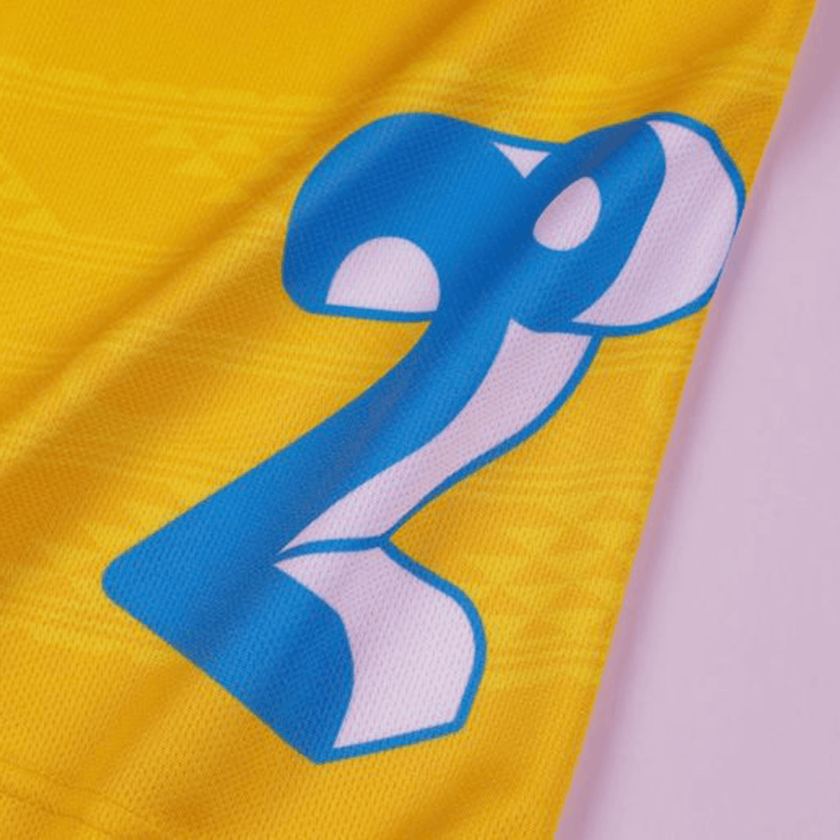 Close-up of a number 29 in blue on a yellow Classic Sportswear Hurricanes Super Rugby 2024 Home Jersey fabric.