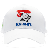 The Knights NRL 25/26 Media Cap by Classic Sportswear is a quick-drying polyester cap featuring a white design with a stylized knight helmet and red plume. "KNIGHTS" is embroidered below, and it includes an adjustable Velcro closure for the perfect fit.