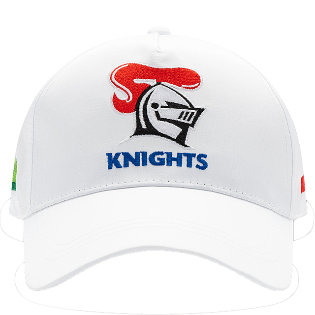 The Knights NRL 25/26 Media Cap by Classic Sportswear is a quick-drying polyester cap featuring a white design with a stylized knight helmet and red plume. "KNIGHTS" is embroidered below, and it includes an adjustable Velcro closure for the perfect fit.