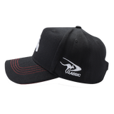 The Rabbitohs NRL 2025 Media Cap by Classic Sportswear features a black design with red stitching on the brim and a white "Classic" logo on the side. Made from quick-drying polyester for enhanced comfort, it includes an adjustable Velcro closure, making it perfect for any adventure or game day.