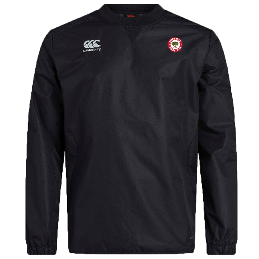 The Chico Oaks Club Vaposhield Contact Top by EMB Canterbury is a black long-sleeve sports shirt with the "canterbury" logo on the left chest and a red emblem on the right, made from durable Micro Diamond ripstop fabric with advanced water repellent technology.