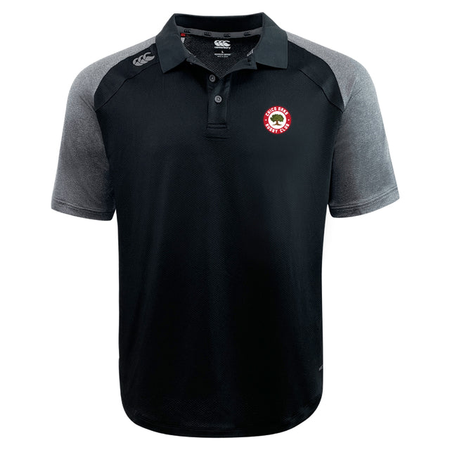 The Chico Oaks Elite Polo by EMB Canterbury is a black and gray short-sleeve shirt made with Vapodri fabrics for lightness and durability, featuring a small red and white emblem on the left chest.