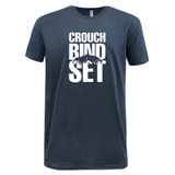 Just In: WRS LAT's Crouch Bind Set Supersoft Tee from the 99 Collection features a navy blue design with white text "CROUCH BIND SET" and a graphic of silhouetted figures in a rugby scrum beneath the word "BIND," capturing the essence of rugby.