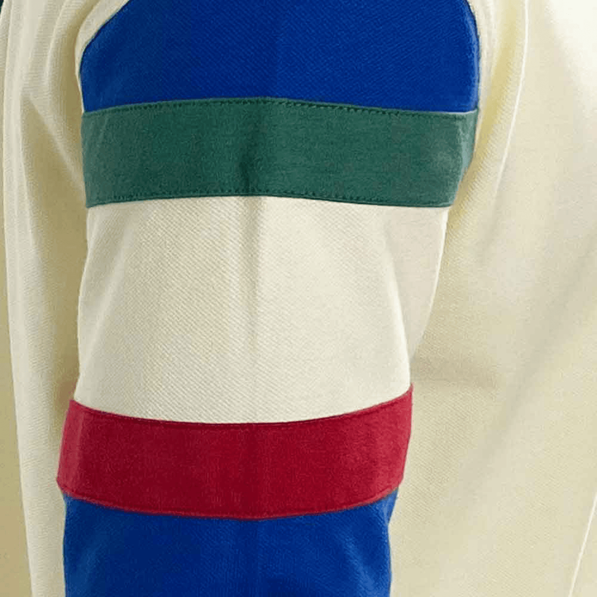 A close up of a man's sleeve with red, blue, and green stripes from the Ellis Rugby International Range Italy Rugby Polo by Ellis Rugby.