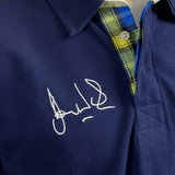 A blue Doddie Weir Polo by Ellis Rugby with the Ellis Rugby signature on it.