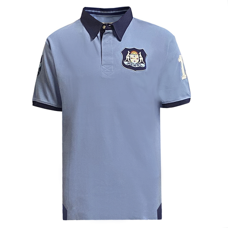 The New South Wales Vintage 1985 Polo by Ellis Rugby is light blue with short sleeves, a dark collar, an embroidered crest on the left chest celebrating State of Origin, and features the number 1 on the right sleeve to highlight its Ellis Rugby heritage.