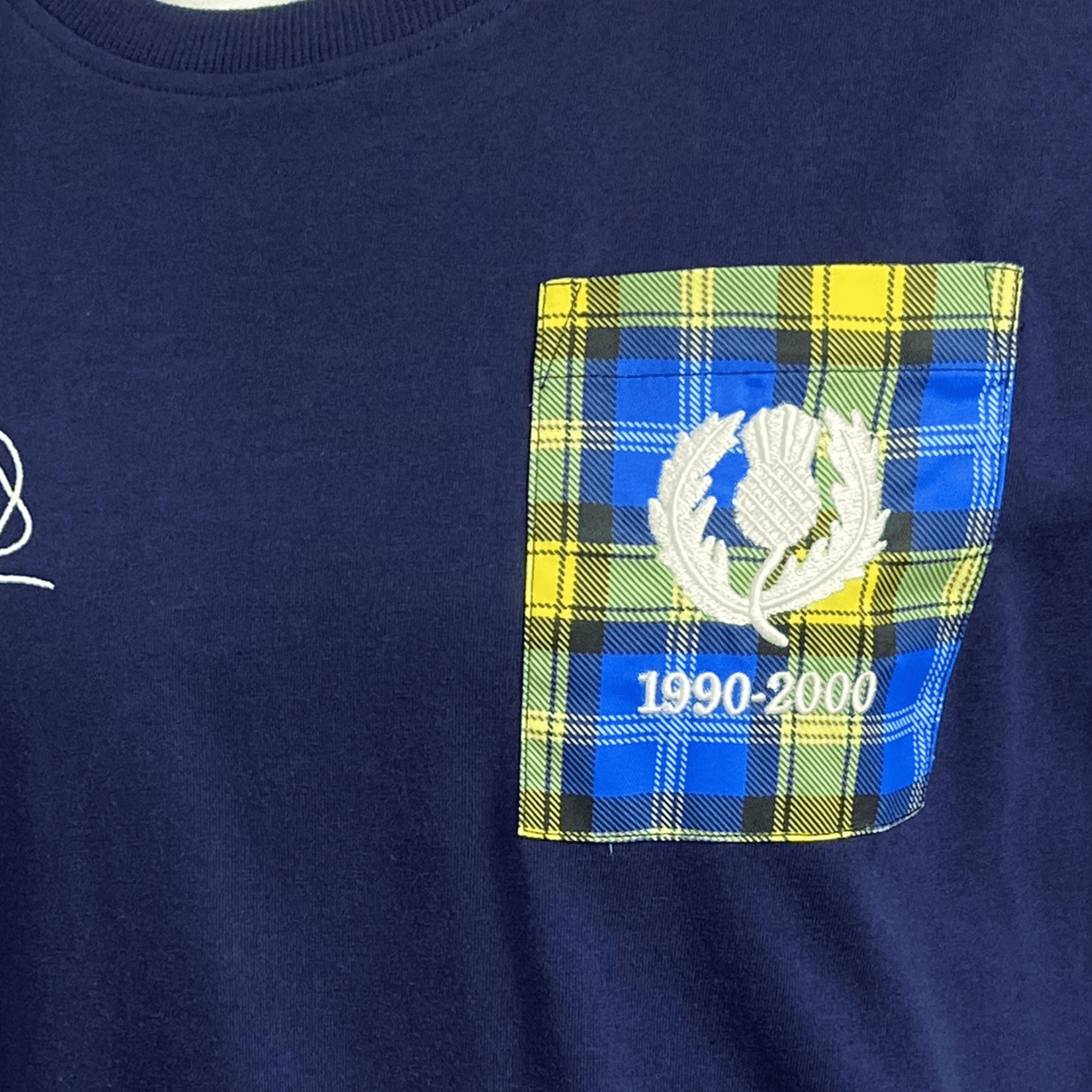 An Ellis Rugby navy t-shirt with a Doddie Weir tartan pocket.