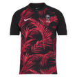 The eye-catching Fiji 24/25 Replica Away Jersey by Nike sports a vibrant black and red design accented with a palm leaf pattern, prominently displaying a logo featuring two crossed palms. Additional logos adorn the sleeves, enhancing this rugby replica jersey's dynamic and authentic appeal.