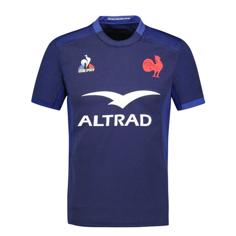 The XV de France FFR Replica Home Jersey 23/24 by Le Coq features a blue design with a rooster emblem, "LE COQ SPORTIF" logo, and "ALTRAD" sponsor branding, celebrating the 2023-2024 XV de France season.