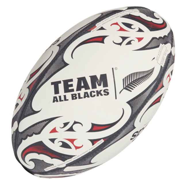 A white "All Blacks Replica Ball by adidas" adorned with black and red Maori patterns and a striking fern logo, crafted by adidas.