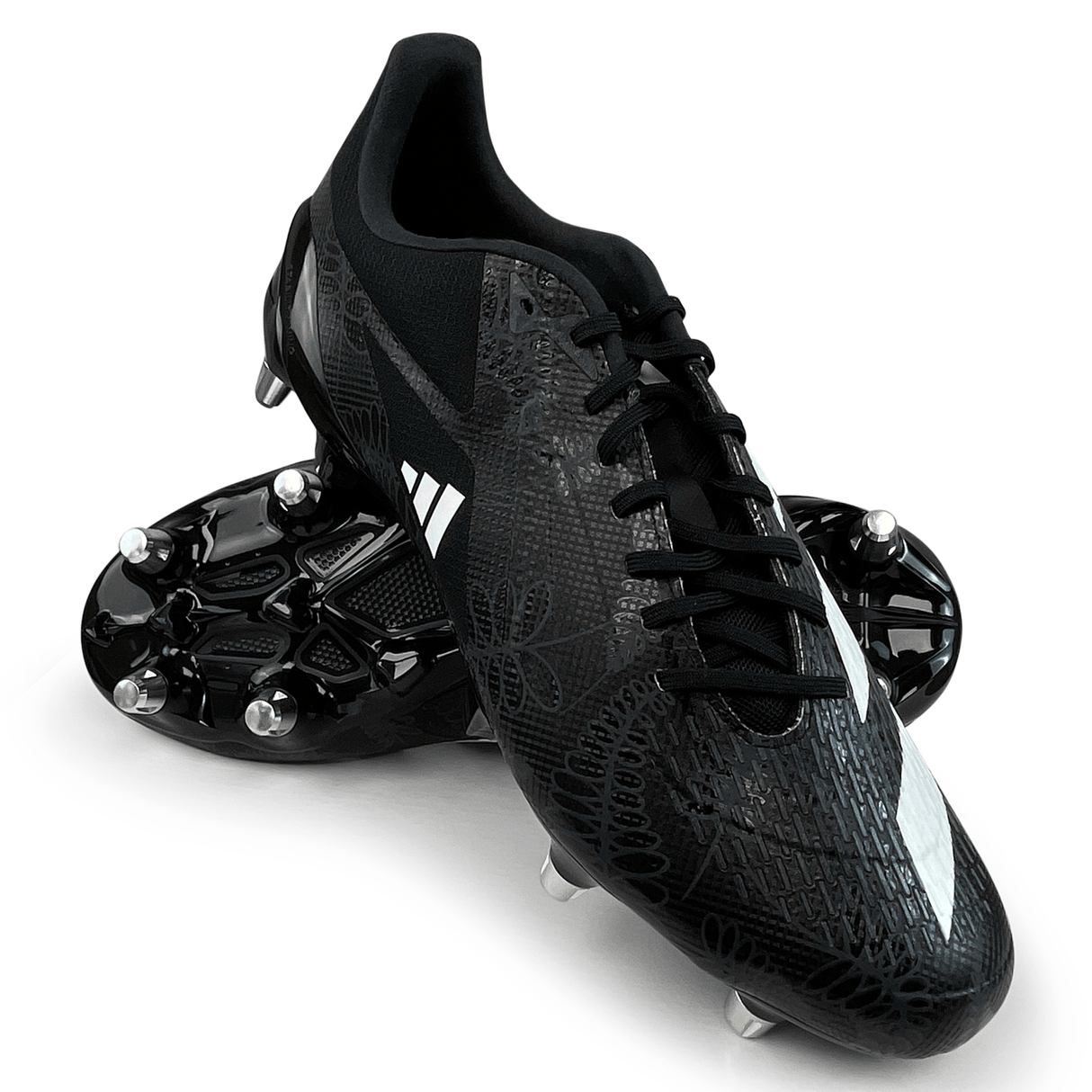 The adidas adizero RS15 Ultimate SG 23 in Core Black/White/Carbon is a lightweight pair of soccer cleats designed for soft ground. They feature reflective accents, a textured upper design, and metal studs on the soles.