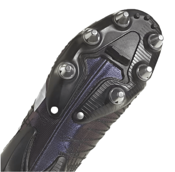 Close-up view of the sole of an adidas Kakari Z.1 SG 23 rugby cleat in Core Black/White/Carbon, showcasing metal studs and a textured pattern designed for soft ground plays.