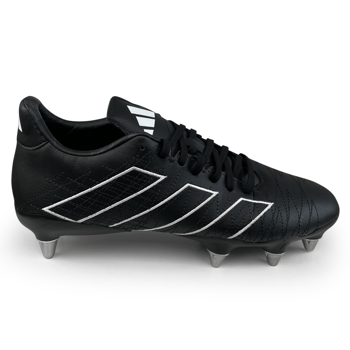 The adidas Kakari Elite SG '23 rugby boot in Core Black/White/Carbon features six metal studs, white accents, black laces, and is crafted from recycled materials, presented on a white background.