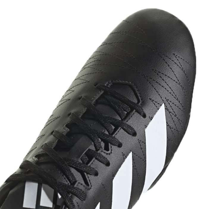 A close-up shot of the adidas Kakari SG rugby boots in Core Black/White/Carbon, showcasing their textured surface, distinctive white diagonal stripes, black laces, and an eight-stud outsole crafted from recycled materials.