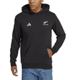 A person wearing the All Blacks Supporters Pull Over Hoodie by adidas, featuring the "All Blacks" logo on the left chest and the Adidas 3 Bar Logo on the right chest, is standing with their left hand in the front pocket. They are also dressed in blue jeans, typical attire for rugby supporters.