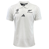 The All Blacks RWC 23 Away Supporter Jersey by adidas is a white collared rugby shirt styled as a replica match jersey, featuring the "World Cup France 2023" and "All Blacks" logos on the chest, with the adidas logo prominently displayed in the center.