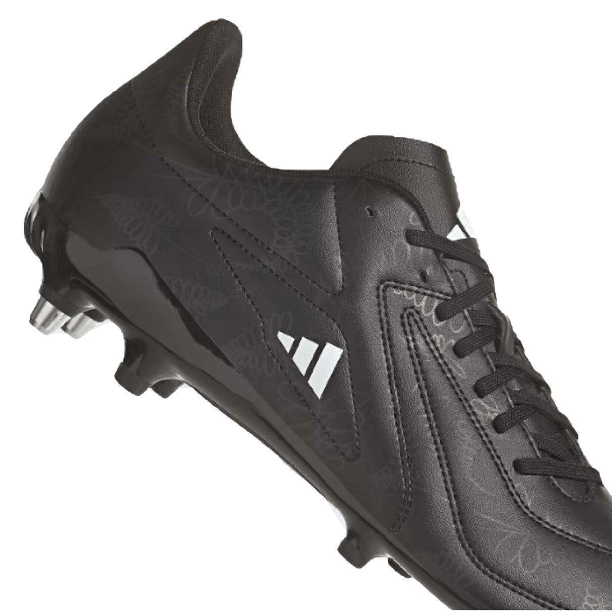 A pair of adidas RS15 SG 23 - Core Black/White/Carbon soccer cleats, featuring white logo accents, metal studs on the sole, and detailed stitching on the upper part. Isolated on a white background. Perfect for soft ground play, these cleats are ideal for rugby athletes under the adidas brand.