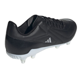 A back-angle view of the adidas RS15 SG in Core Black, Zero Metallic, and White highlights the Sprintframe stability of these soccer cleats, featuring white studs on the sole for enhanced performance.