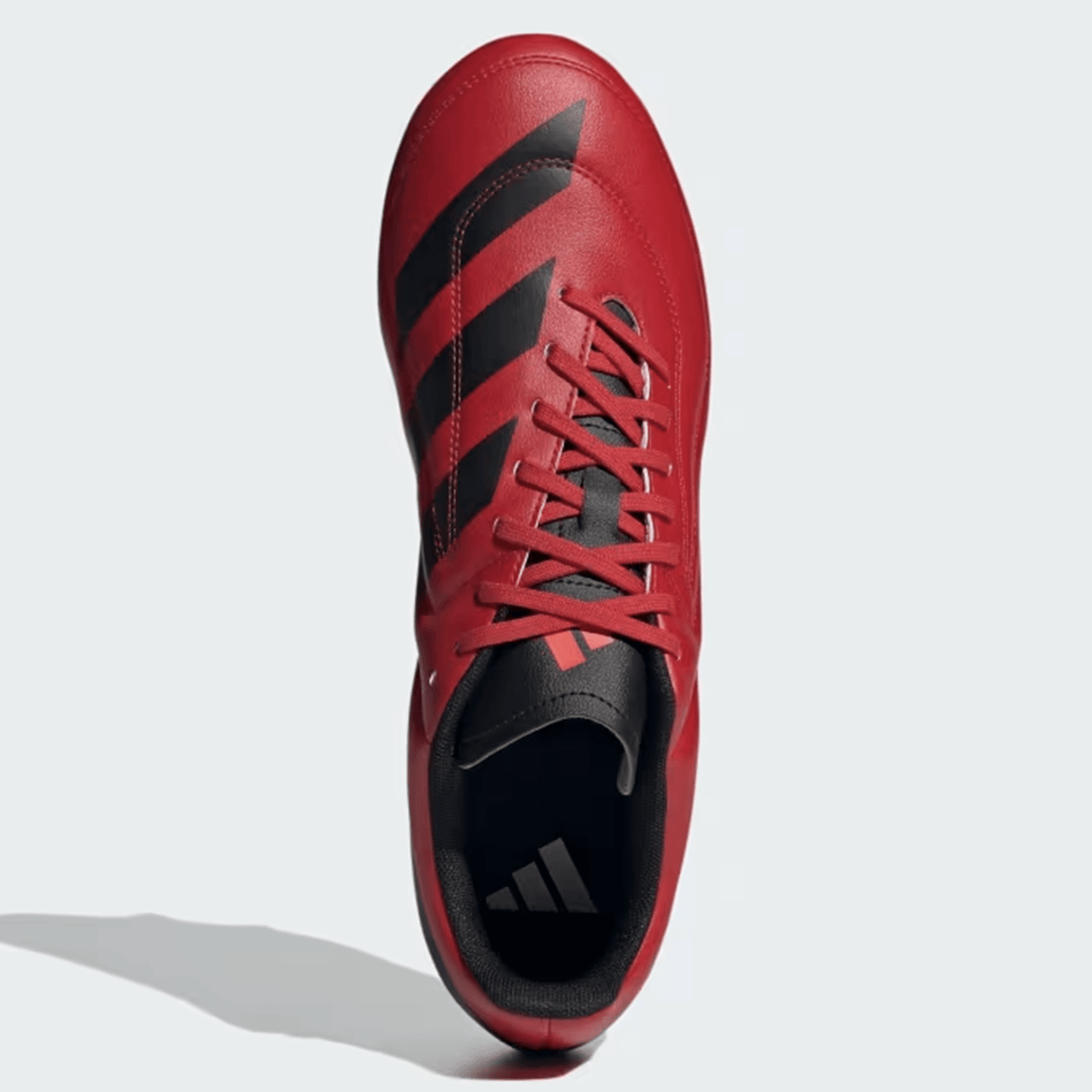 The adidas RS15 SG 24 in Better Scarlet/Core Black/Solar Red is an athletic shoe featuring black stripes along the sides and a black logo on the sole. It has a lightweight synthetic forefoot and is strikingly visible from above with its bold red and black colors.