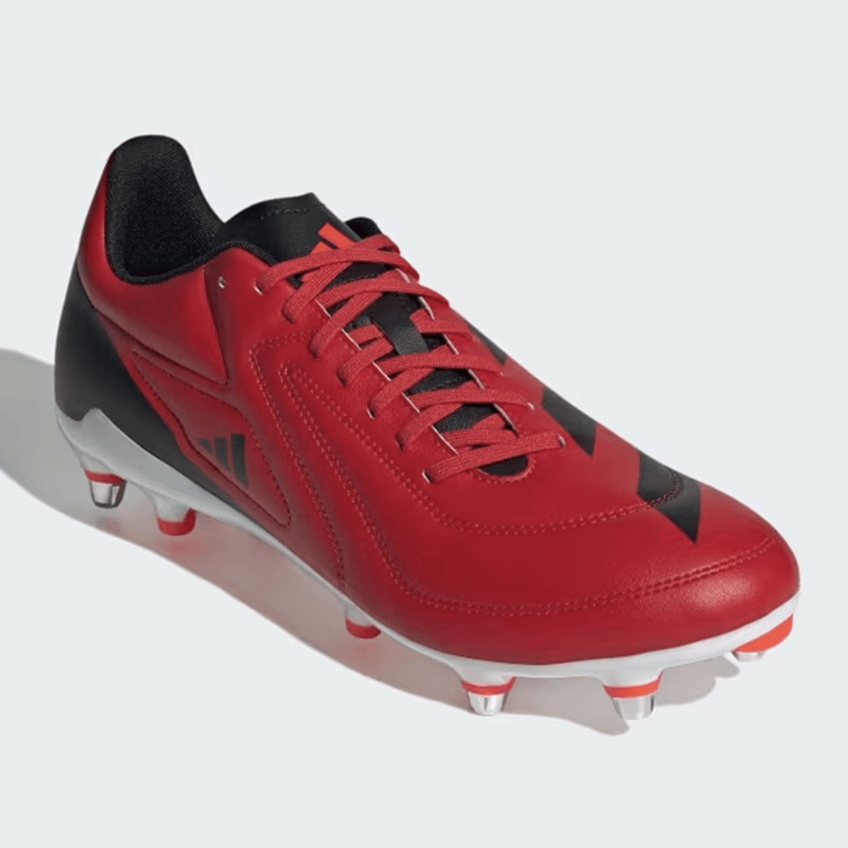 A Better Scarlet/Core Black/Solar Red adidas RS15 SG 24 Rugby Cleat with metal studs, featuring a lace-up design, lightweight synthetic forefoot, Speedframe outsole, and brand logo on the side.