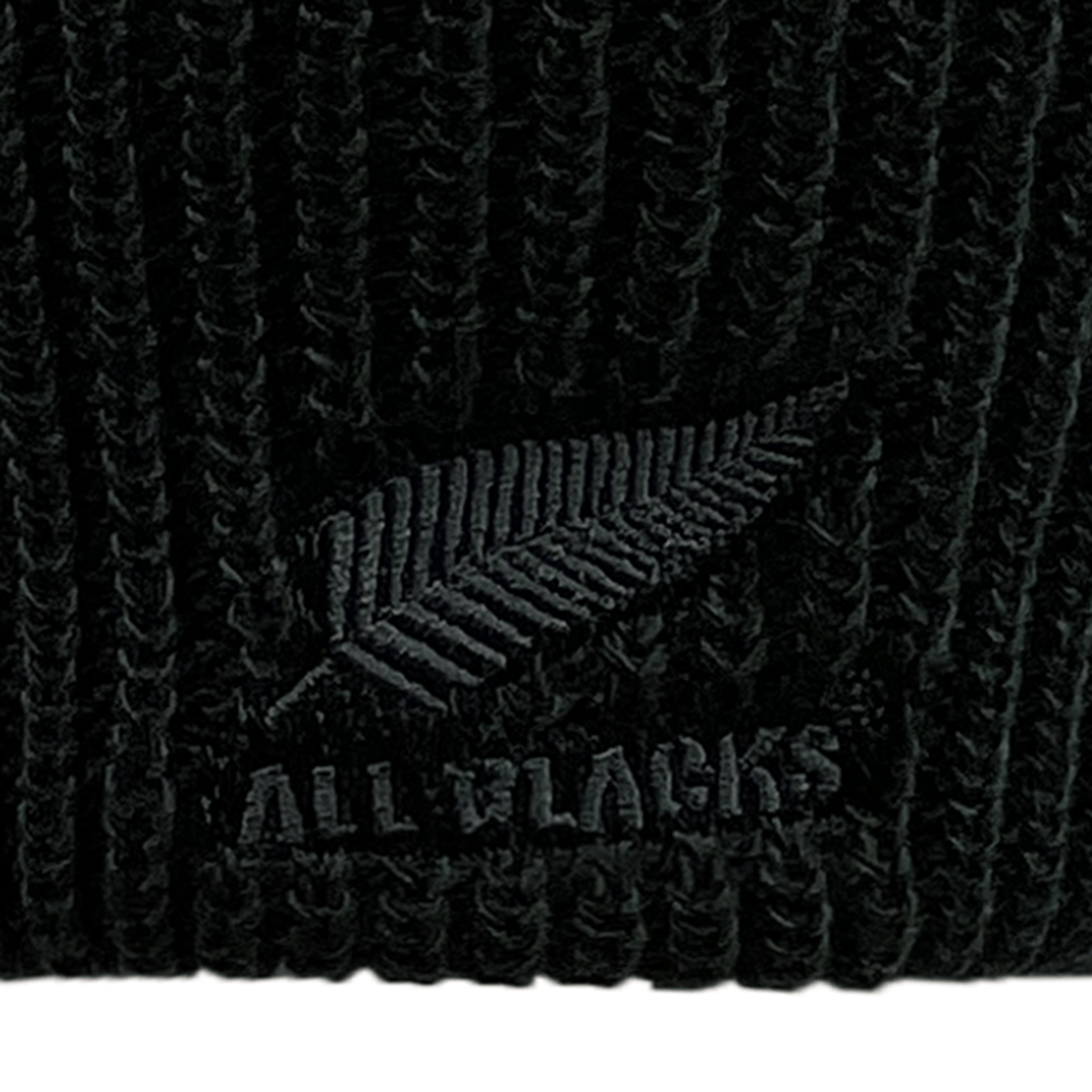 Close-up of an adidas All Blacks Beanie showcasing a black knit design with an embroidered silver fern and the text "ALL BLACKS" on the front, proudly displaying the All Blacks crest.