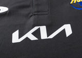 Close-up of a black fabric showcasing the white Kia logo, accented by vibrant embroidery in the upper right, reminiscent of Hurricanes Super Rugby 25/26 Team Polo by Classic Sportswear's design flair.