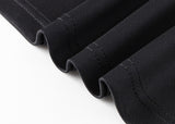 Close-up of neatly stitched black fabric folds on a white surface, reminiscent of the precision in the Hurricanes Super Rugby 25/26 Team Polo by Classic Sportswear.