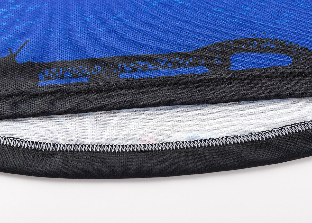 Close-up of blue fabric with black stitching from the Blues Super Rugby 25/26 Replica Home Jersey by Classic Sportswear, featuring a bridge silhouette.